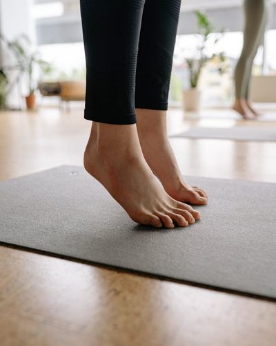 Close-up of a person's feet on a yoga mat, showing stability.